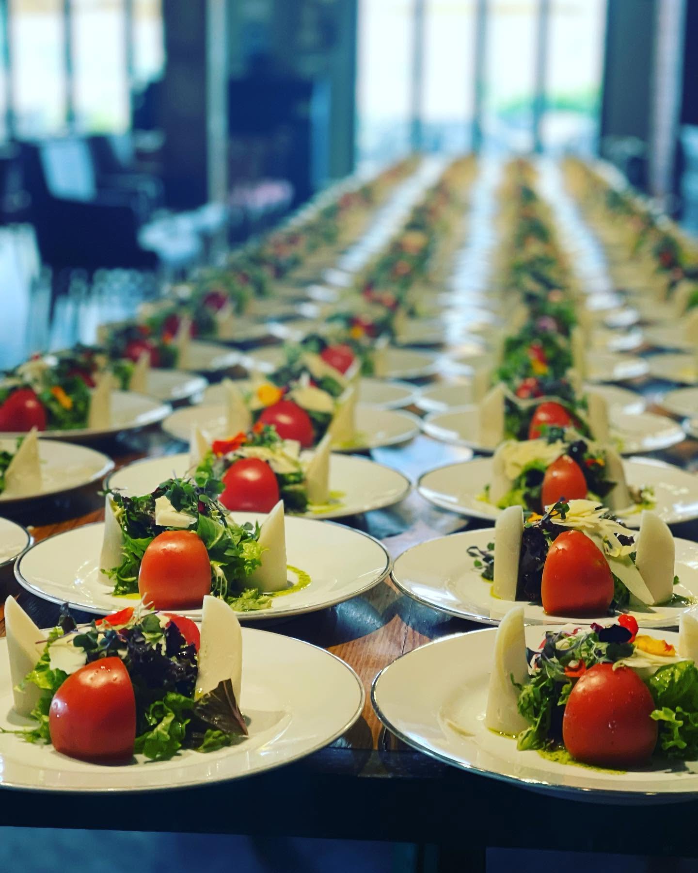 A long table set with tomato and mozzarella starters