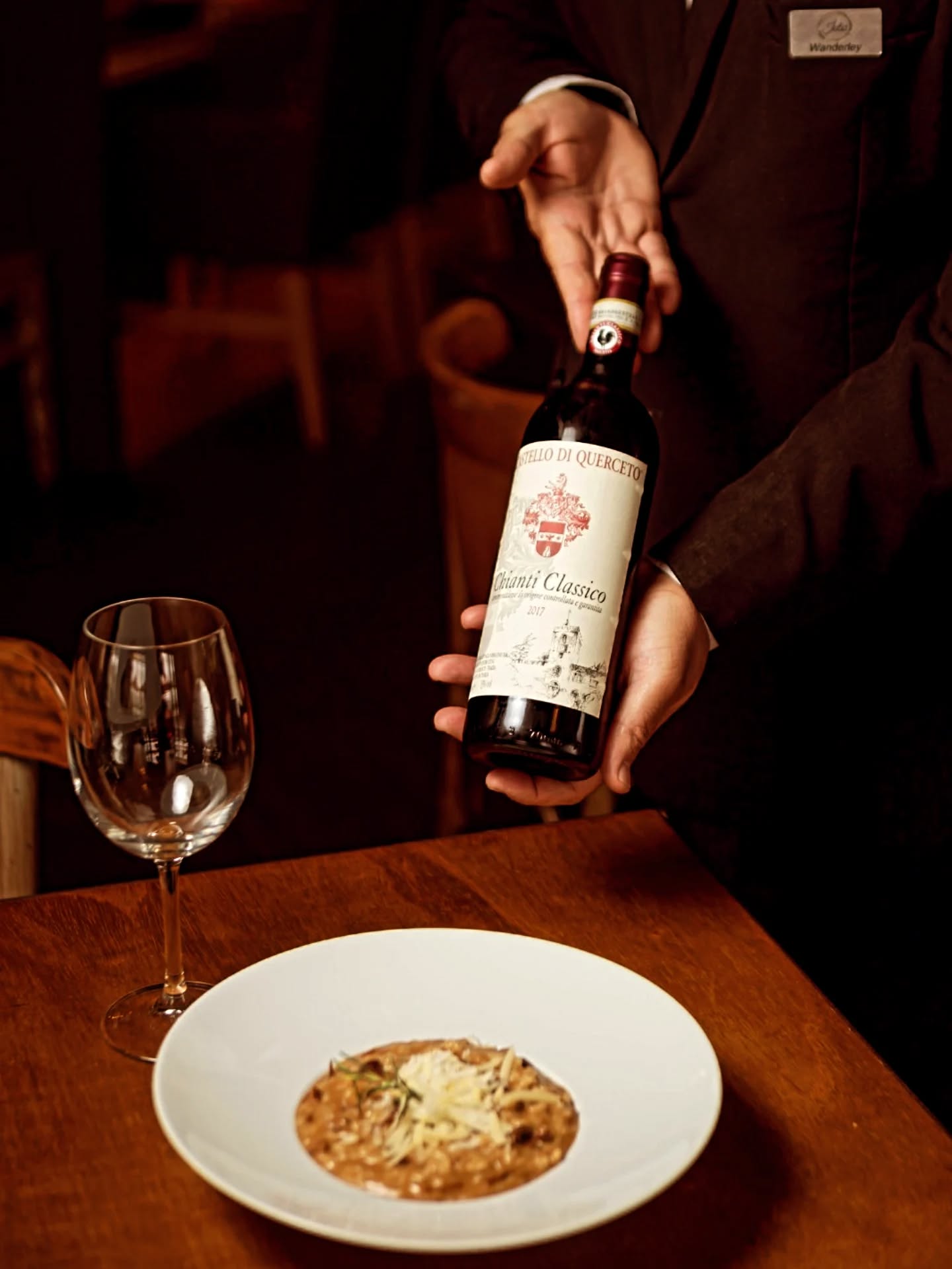 A sommelier serving a Chianti Classico at the table